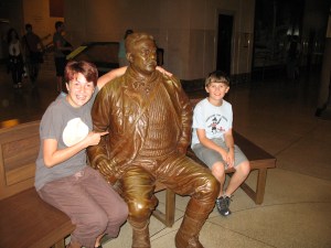 Laurel, doing her Stephen Colbert impression, with Teddy Roosevelt at the Natural History Museum