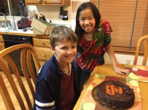 Charlie and his cousin Rachel with the flourless chocolate cake that Aunt Barb & Uncle Ray bought him