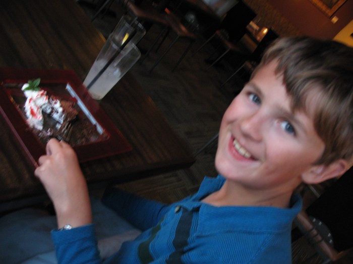 The birthday boy enjoying his flourless, chocolate cake at a Yachats restaurant