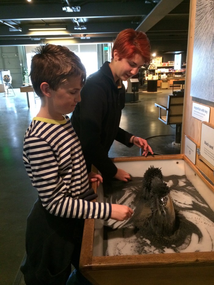 Playing with iron sand and a magnet at the Exploratorium