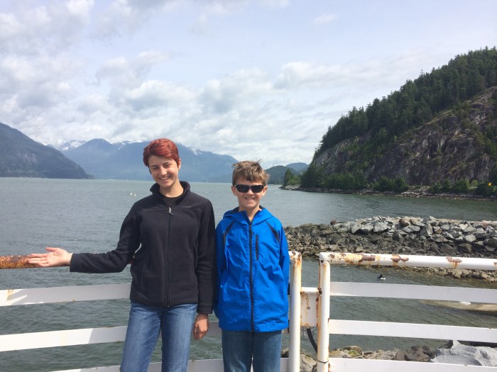 Our taxi driver pulled over in a parking lot near the Sea to Sky Highway on the way home Whistler on June 8, so we could take some pictures.  We climbed some stairs to go out on this ledge and get some good scenery shots.  Laurel is trying to cover up the rusty railing.