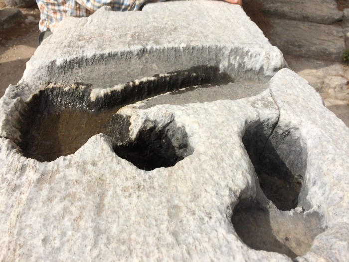 This is the top of a water clock in the amphitheater.  Water clocks allowed people to keep time even after the sun had set and they couldn't use the sun dial.