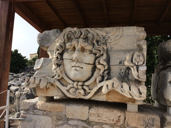 The face of Medusa was carved into pieces of the marble (now on the ground) that went over the columns of Apollo's temple.  Medusa warded off bad spirits and bad emotions such as jealousy before people entered.  The eye of Medusa is a popular amulet in Turkey with the "eye" jewelry and household wallhangings for sale everywhere.