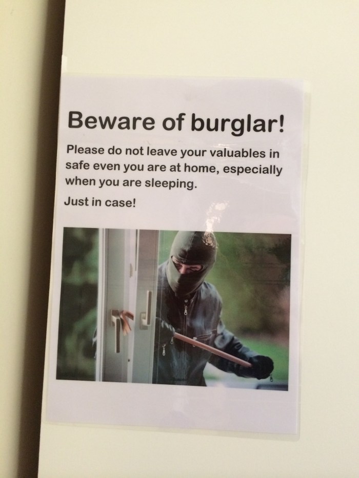 This bizarre sign is taped to the side of a cabinet in our apartment...just above the safe the owner has provided.